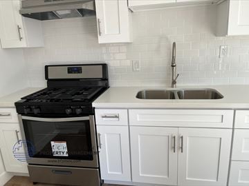 Gardena apartment for rent - a white kitchen with a stove and a sink